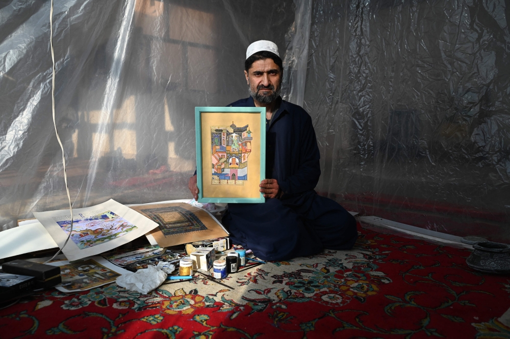 This picture taken on January 7, 2026 shows Mohammad Younes Qane, an Afghan miniature artist at his house in Herat. Hundreds of years after the celebrated painter Kamal ud-Din Behzad roamed the streets of Herat, artists in the Afghan city are finding joy and hope in his recognition by Unesco. Since Qane was a teenager, the 45-year-old has been practising Behzad's celebrated miniature art style, which inspired French artist Henri Matisse. — AFP pic