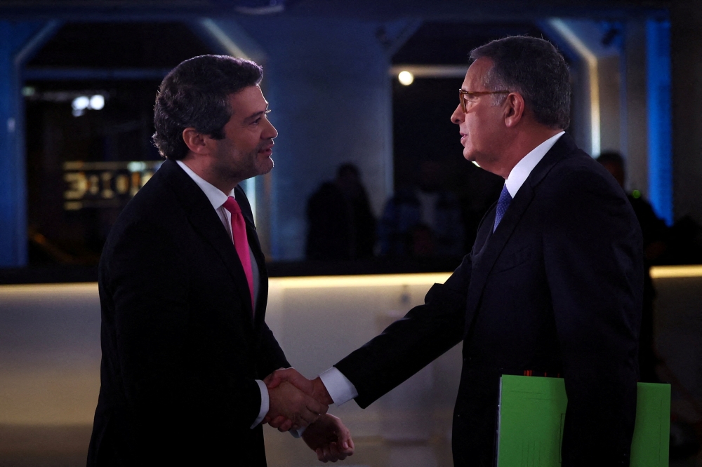 Far-right leader Andre Ventura shakes hands with moderate Socialist Antonio Jose Seguro before a debate ahead of the presidential runoff, in Lisbon, Portugal, January 27, 2026.  — Reuters pic