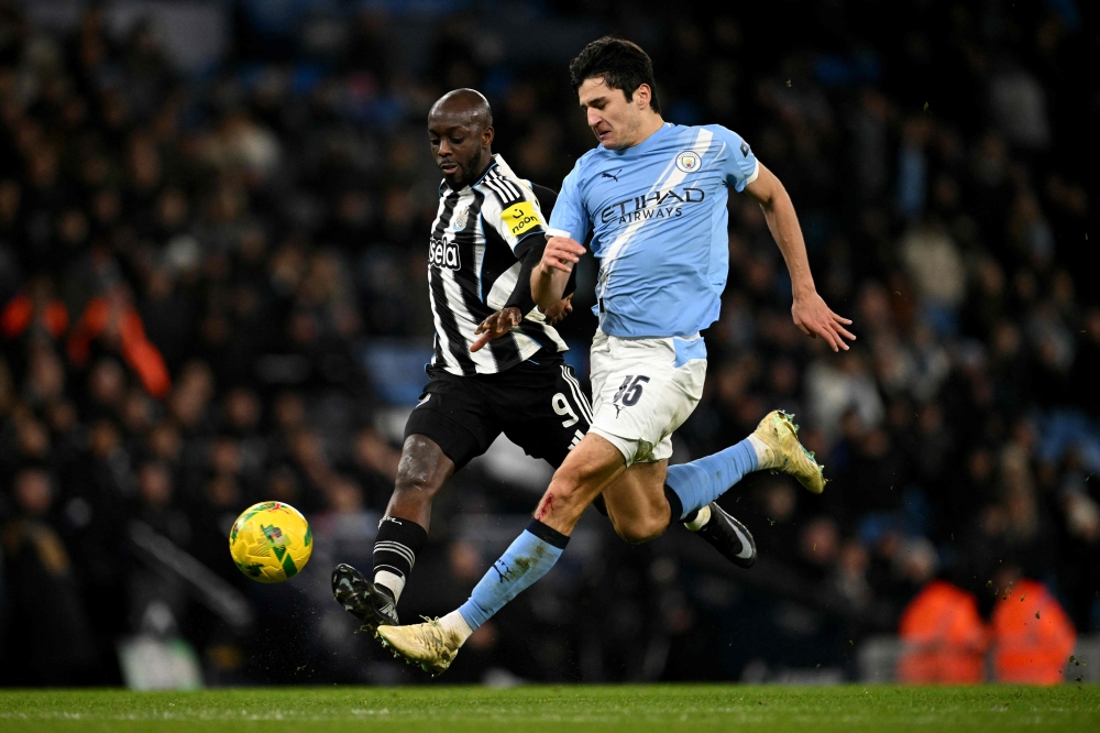 Newcastle United's Congolese striker #09 Yoane Wissa battles for possession with Manchester City’s Uzbek defender #45 Abdukodir Khusanov during the English League Cup semi final second leg football match between Manchester City and Newcastle United at the Etihad stadium in Manchester, north-west England on February 4, 2026. — AFP pic 