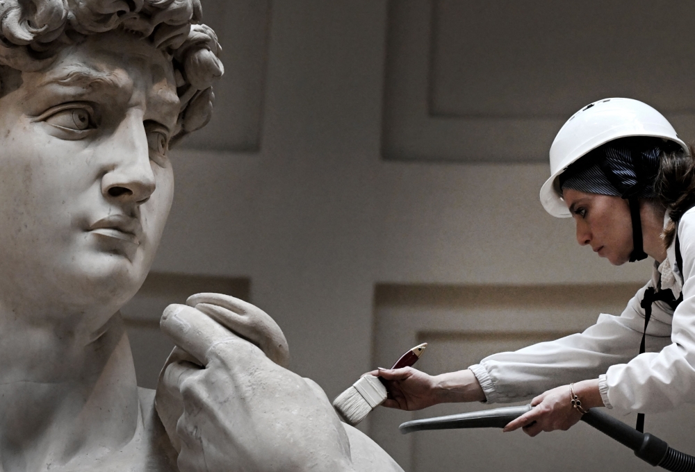 Italian restorer Eleonora Pucci cleans Michelangelo’s statue of David at the Galleria dell’Accademia, in Florence on February 19, 2024. — AFP pic
