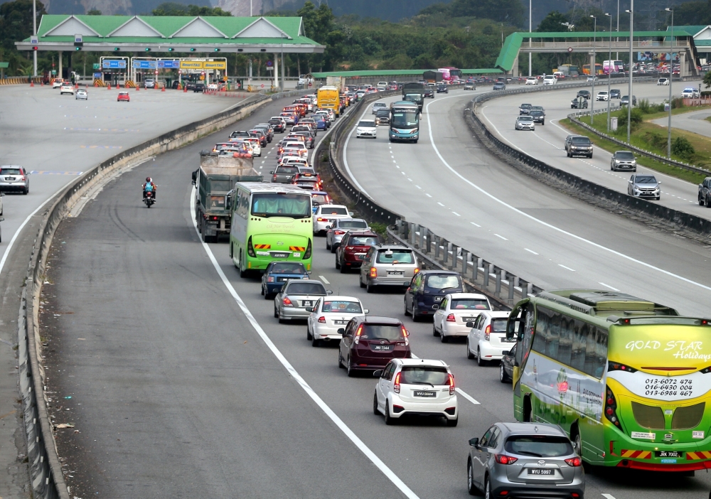 File picture of traffic moving slowly at the North-South Expressway heading north near the Ipoh toll exit following the end of a long break after Chinese New Year. — Picture by Farhan Najib