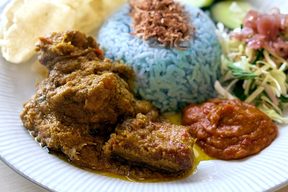 The tenderness of the ‘rendang’ pork ribs makes the Nasi Kerabu worth the return visit. — Picture by CK Lim
