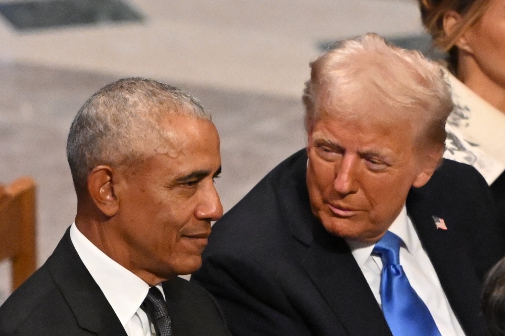 US President-elect Donald Trump speaks with former President Barack Obama as they attend the State Funeral Service for former US President Jimmy Carter at the Washington National Cathedral in Washington, DC, in this file photo taken on January 9, 2025. US President Donald Trump triggered outrage yesterday after he posted a video depicting Barack Obama, the first Black president in American history, and his wife Michelle as monkeys. The White House said that the post was made in error by a staff member, and has been removed. — AFP pic 