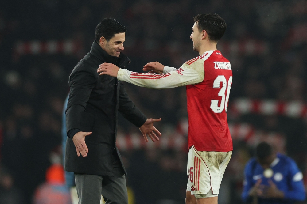 Arsenal's Spanish manager Mikel Arteta (left) embraces Arsenal's Spanish defender #36 Martin Zubimendi (right) after the English League Cup semi final second leg, football match between Arsenal and Chelsea at the Emirates Stadium, in London on February 3, 2026. — AFP pic