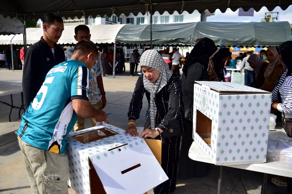 Election officials inspect ballot boxes at the municipality office in Narathiwat on February 7, 2026, before carrying them to a polling station. — AFP pic
