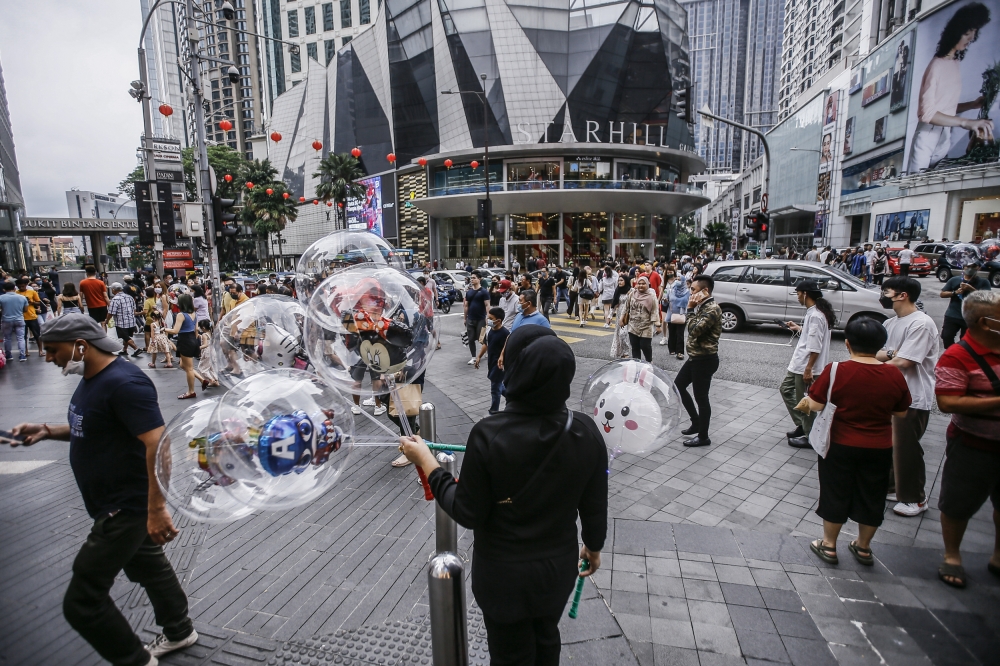 Number of foreign tourists working illegally in Malaysia rising, hurting local businesses, says home minister