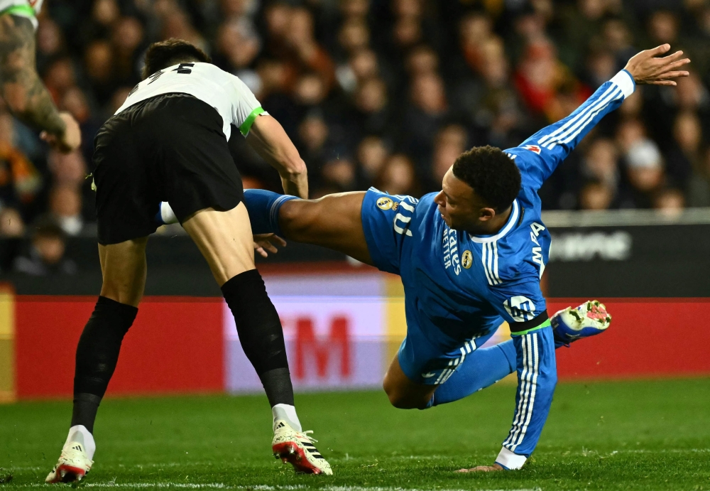 Real Madrid’s French forward Kylian Mbappe (right) fights for the ball with Valencia’s Spanish midfielder Pepelu during the Spanish league football match between Valencia CF and Real Madrid CF at Mestalla Stadium in Valencia on February 8, 2026. — AFP pic