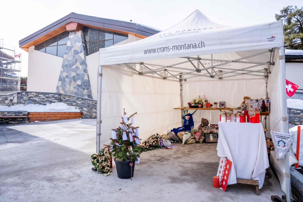 This photograph shows a newly erected memorial tent near the Chapelle Saint-Christophe in Crans-Montana, after a fire early on February 8, 2026, damaged the previous memorial site near the bar ‘Le Constellation’ in tribute to the victims of the fatal fire that ravaged the bar on New Year's Eve. 