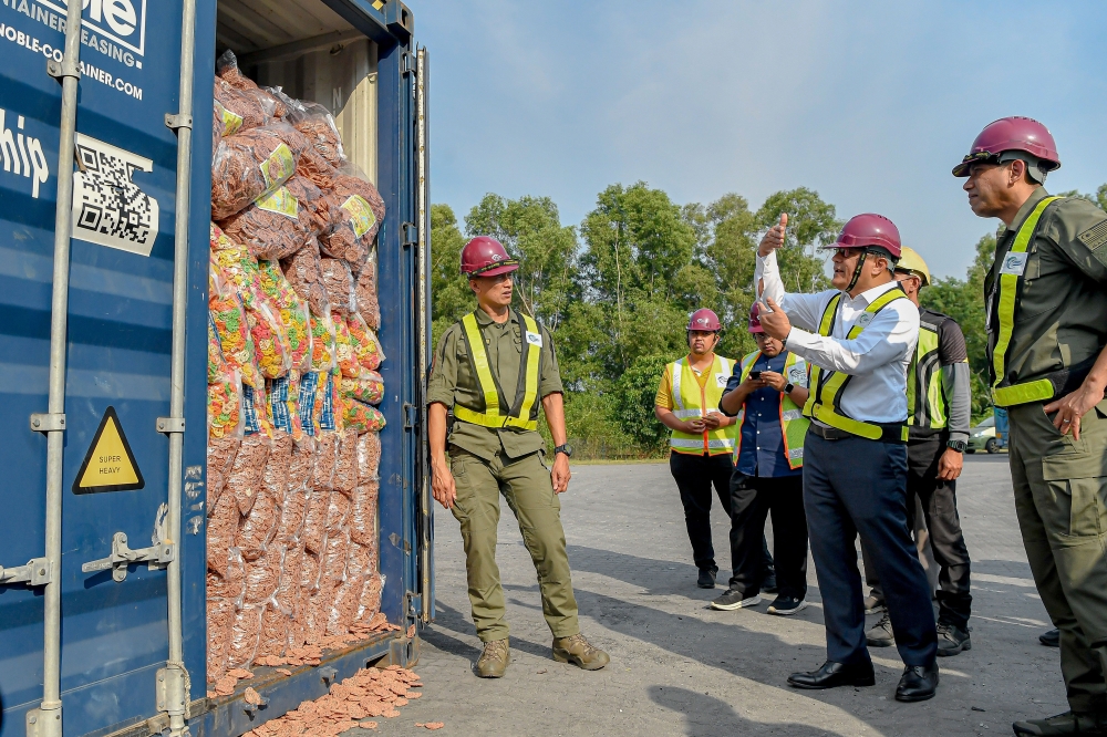 Attorney General Tan Sri Mohd Dusuki Mokhtar (second from right) observes the inspection process of containers detained for examination during a working visit to the Malaysian Border Control and Protection Agency (AKPS) at Westport, Pulau Indah, February 9, 2026. Also present was AKPS director-general Datuk Seri Mohd Shuhaily Mohd Zain. — Bernama pic 