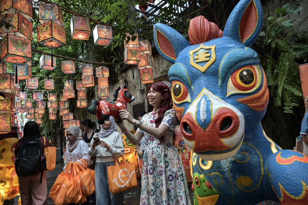 Visitors step onto the iconic Red Bridge at Kwai Chai Hong, Kuala Lumpur, adorned with colourful zodiac lanterns for the ‘Guardians of Legacy’ Chinese New Year installation, February 11, 2026. — Bernama pic