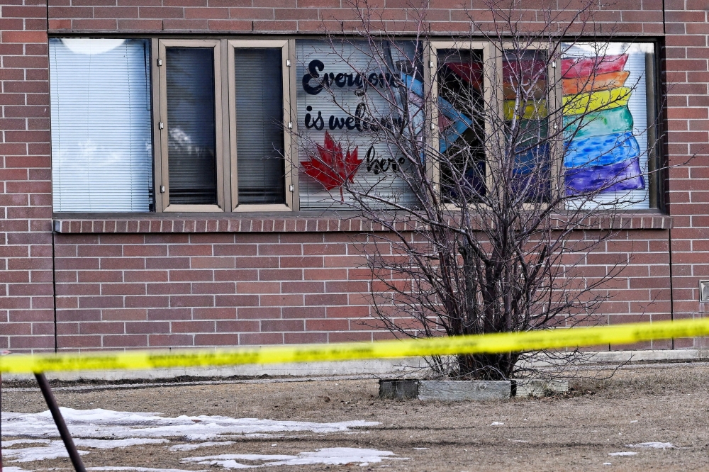 Crime scene tape surrounds a high school with a Pride flag and ‘Everyone is welcome here’ painted on windows, at the site of a deadly mass shooting in the town of Tumbler Ridge, British Columbia, Canada February 11, 2026. — Reuters pic 