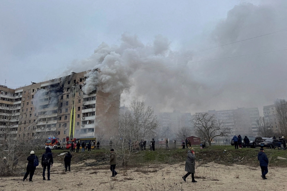 Residents walk in front of an apartment building hit by a Russian air strike, amid Russia’s attack on Ukraine, in Zaporizhzhia, Ukraine, December 17, 2025.  — Reuters pic