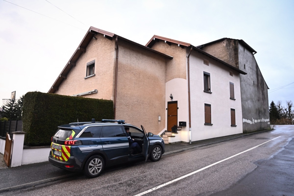 French Gendarmes gather outside the house where the bodies of two infants have been discovered in a freezer in Ailleviller-et-Lyaumont, eastern France on February 12, 2026. — AFP pic