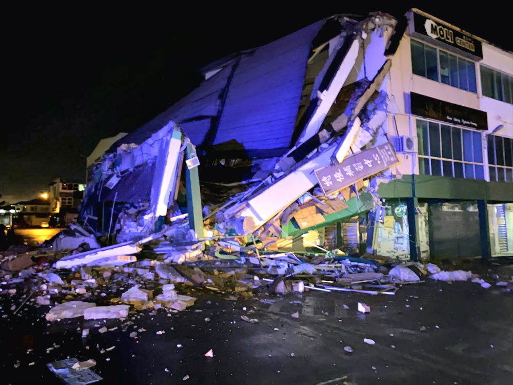 The corner unit of a shophouse block in Sungai Merah here collapsed onto the road below early Friday morning. — The Borneo Post