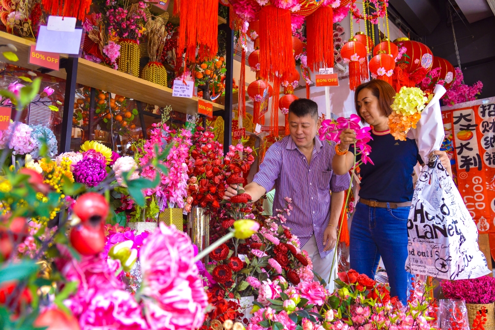 Private sector employee Cheong Mun Keng, 55, and his wife Lina are busy choosing festive decorations in preparation for the upcoming Chinese New Year at a decorative items shop along Petaling Street, Kuala Lumpur, February 13, 2026. — Bernama pic 