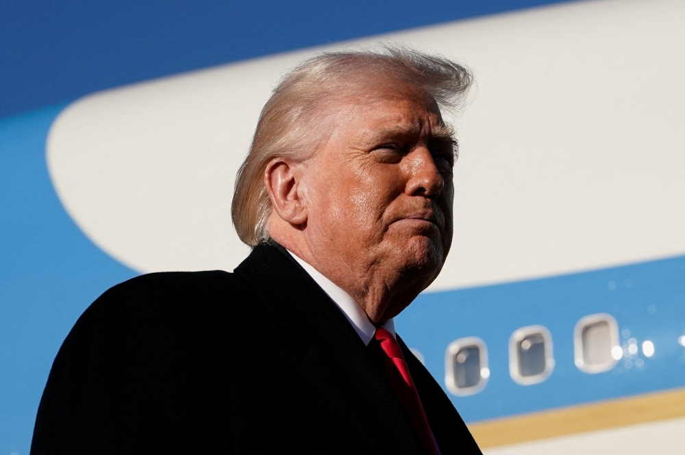US President Donald Trump looks on before boarding Air Force One en route to Florida, at Pope Army Airfield on Fort Bragg, North Carolina February 13, 2026. — Reuters pic