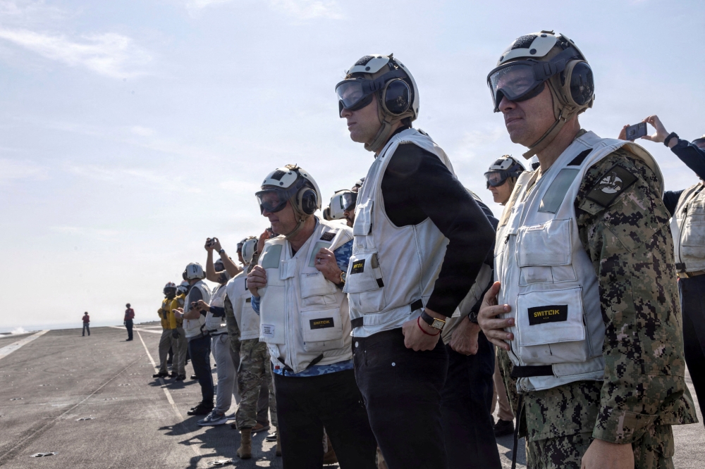 US Special Envoy for Peace Missions Steve Witkoff, Jared Kushner and US Navy Admiral Brad Cooper, commander of US Central Command, observe flight operations aboard Nimitz-class aircraft carrier USS Abraham Lincoln in the Arabian Sea, February 7, 2026. — US Navy/Mass Communication Specialist 2nd Class Sonny Escalante handout pic via Reuters