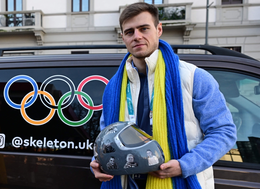 Ukrainian skeleton athlete Vladyslav Heraskevych poses with his helmet after a hearing at the Court of Arbitration for Sport in Milan on February 13, 2026. Heraskevych was barred from the Milan-Cortina Games after refusing to back down from wearing a helmet adorned with pictures of Ukrainian sportsmen and women killed since Russian invaded in 2022. — AFP pic 