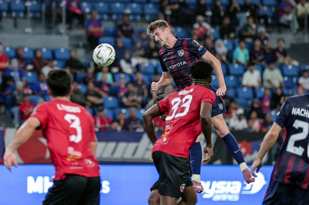 JDT player Oscar Aribas Pasero (centre) managed to head home an unmarked header from Melaka FC in the first quarter-final of the 2025/2026 Malaysia Cup at the Sultan Ibrahim Stadium February 13, 2026. — Bernama pic