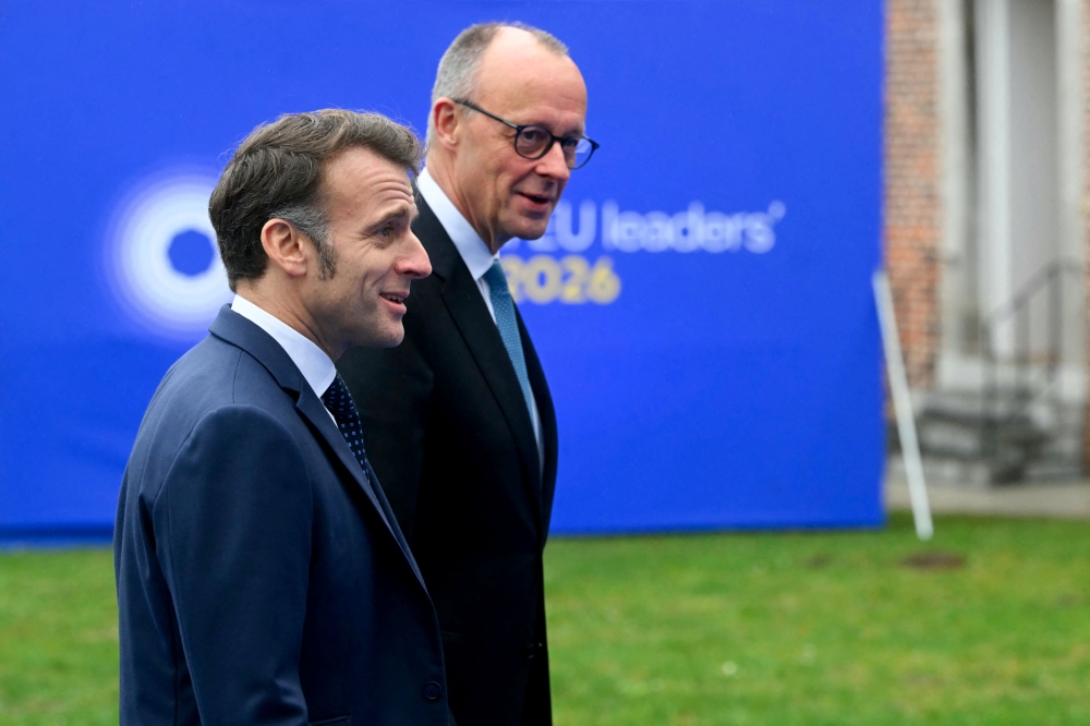 France's President Emmanuel Macron (left) and Germany's Chancellor Friedrich Merz arrive to attend the Informal EU Leaders' Retreat at the Alden Biesen Castle in Alden Biesen, central Belgium on February 12, 2026. — AFP pic 
