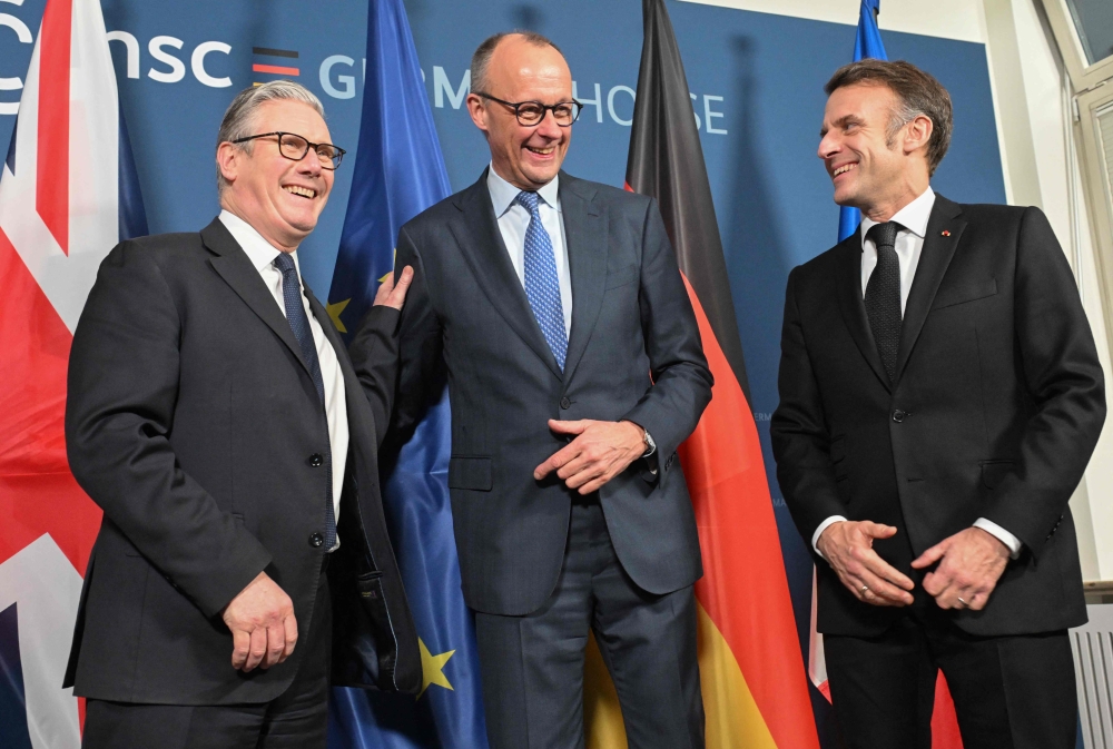 (From left) British Prime Minister Keir Starmer, German Chancellor Friedrich Merz and France’s President Emmanuel Macron pose at the start of the E-3 meeting, during the Munich Security Conference, on February 13, 2026 in Munich. — Thomas Kienzle/Pool/AFP pic