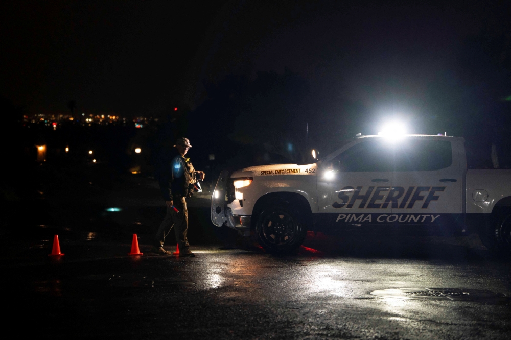 A Pima County Sheriff’s deputy maintains a roadblock as a suspected raid regarding the disappearance of Nancy Guthrie, the 84-year-old mother of US journalist and television host Savannah Guthrie, takes place on a residential street in Catalina Foothills in Tucson, Arizona February 13, 2026. — Reuters pic  