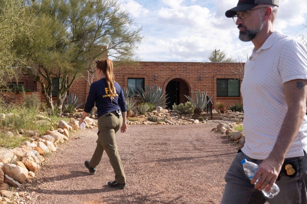 Investigators search Nancy Guthrie’s property in the Catalina Foothills after the disappearance of Guthrie, the 84-year-old mother of US journalist and television host Savannah Guthrie, who went missing from her home in Tucson, Arizona February 11, 2026. — Reuters pic  