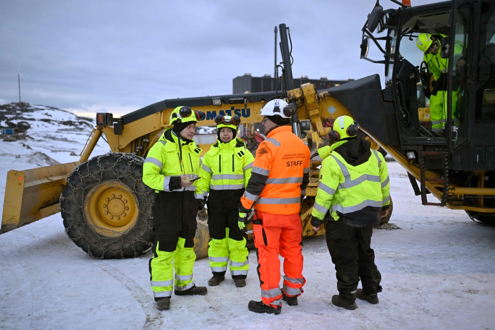 Teacher Kim Heilmann instructs his students before practicing driving excavators on the school grounds of the Greenland School of Minerals and Petroleum in Sisimiut, Greenland, on February 2. — AFP pic