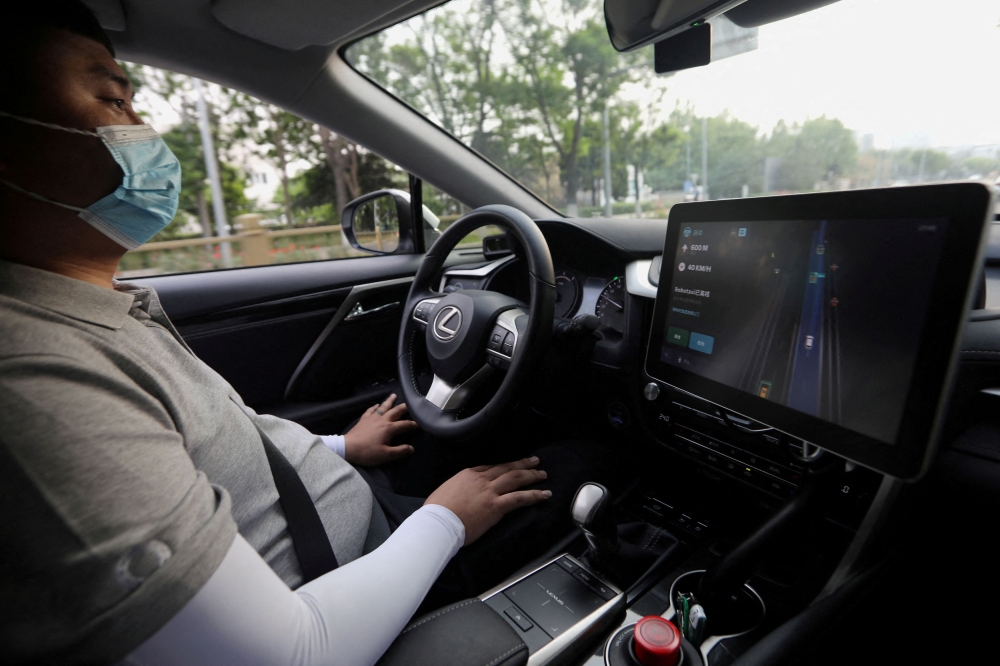 China’s top court has issued a ruling confirming humans in cars with assisted driving technology are responsible for their vehicle, setting a nationwide benchmark as Beijing positions itself as a standards-setter in the auto market. — Reuters pic