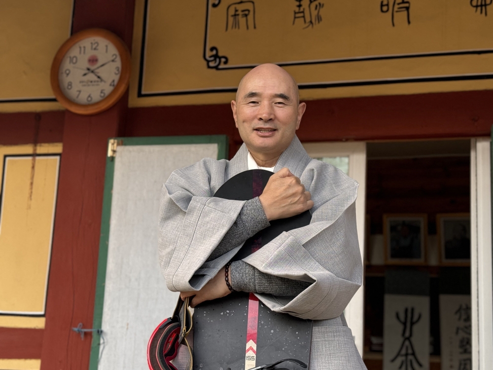 This picture taken on on February 12, 2026 shows Venerable Hosan, head monk of Bongsunsa Temple, posing for a photo with his snowboard during an interview at the temple in Namyangju. — Yonhap/AFP pic 