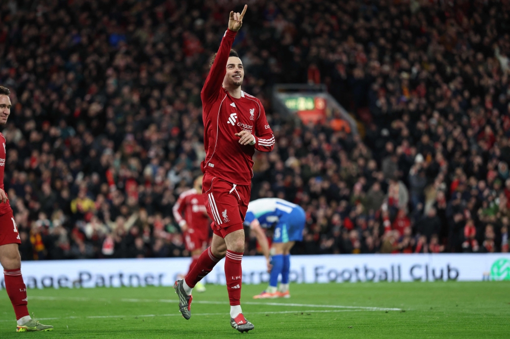 Liverpool's English midfielder  Curtis Jones celebrates after scoring the opening goal of the English FA Cup fourth round football match against Brighton. — AFP pic