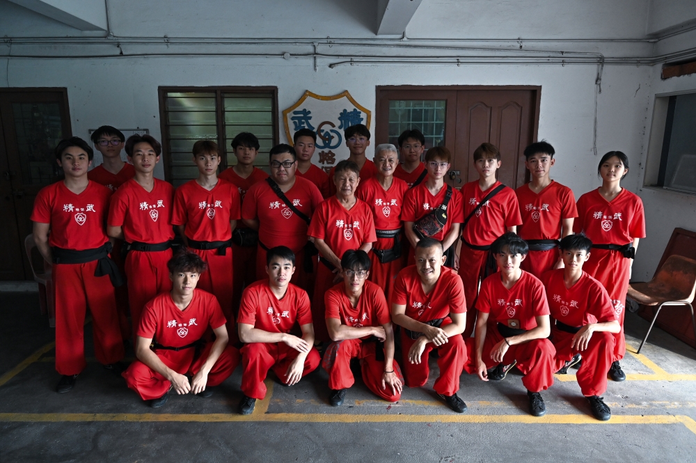Tan Chooi Eng (centre), affectionately known as ‘Sifu Tan’ from the Perak Chin Woo Association, poses with his students during a recent meeting. — Bernama pic