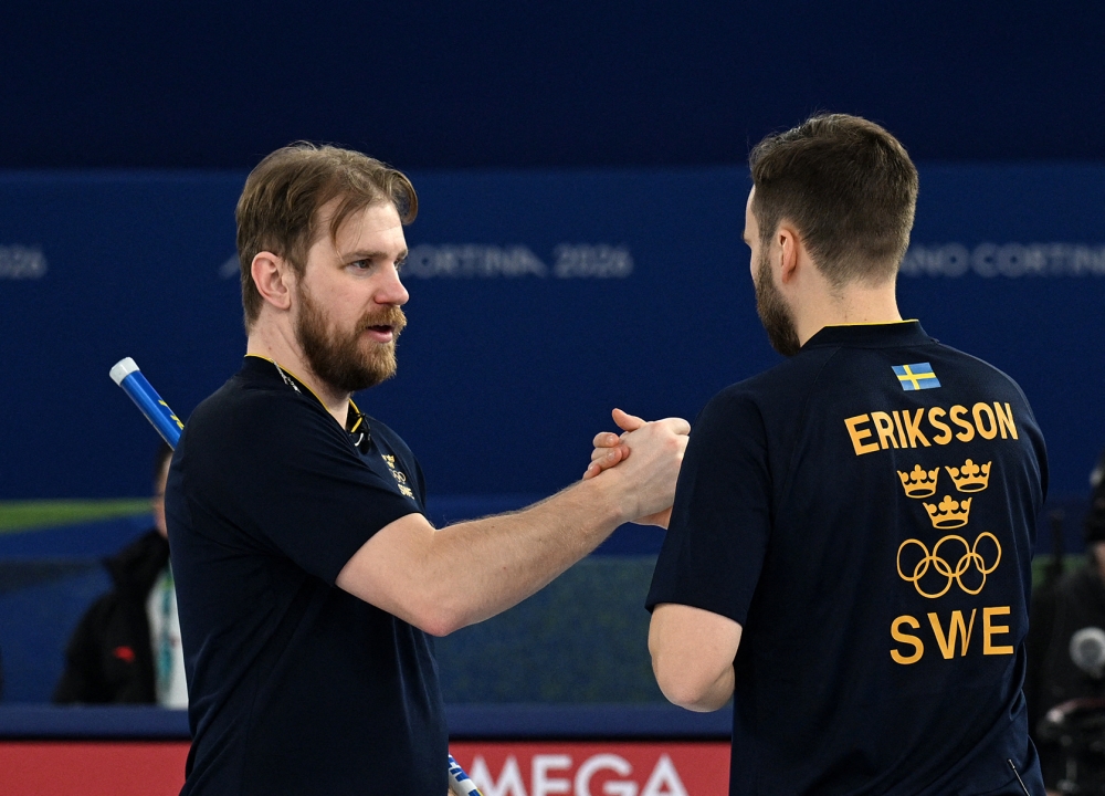 Sweden’s Rasmus Wranaa and Oskar Eriksson celebrate their win over China during the men’s round robin curling session at the Milano Cortina 2026 Winter Olympics at the Cortina Curling Olympic Stadium in Italy. — Reuters pic