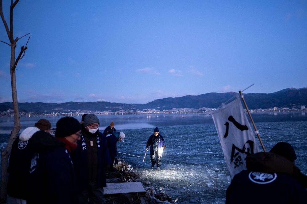 The Japanese priest and his parishioners gathered before dawn, hoping that climate change had not robbed them of the chance to experience an increasingly rare communion with the sacred. — AFP pic