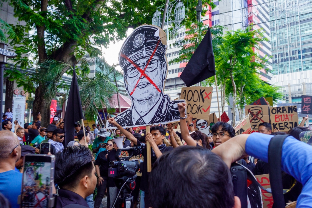 Protesters hold placards during a rally against Malaysian Anti-Corruption Commission (MACC) chief commissioner Tan Sri Azam Baki, in front of the Sogo shopping complex in Kuala Lumpur on February 15, 2026. — Picture by Raymond Manuel