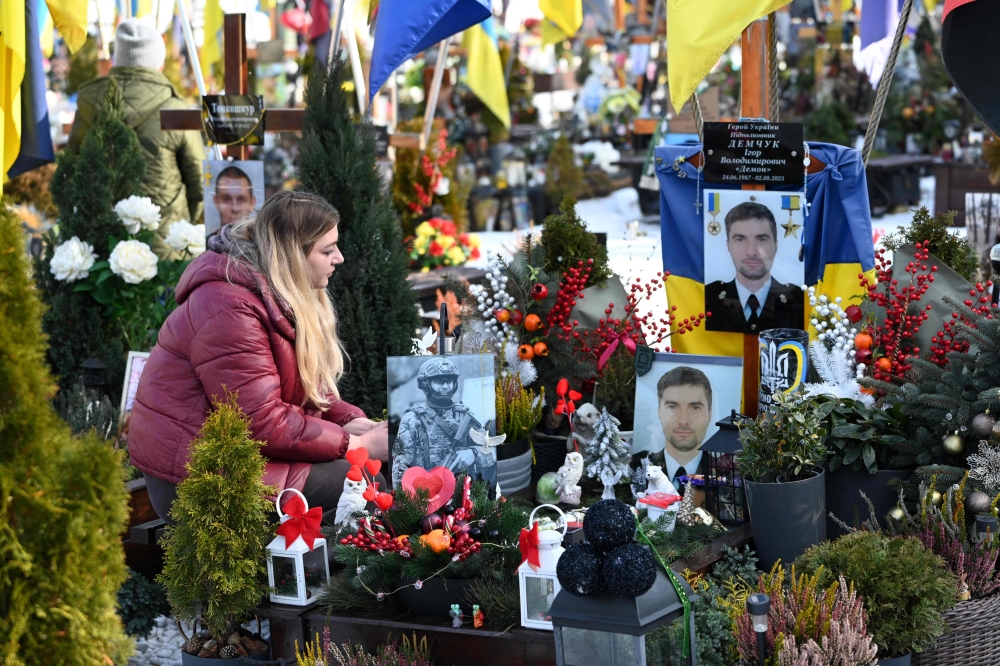 Widow visits soldier’s grave on Valentine’s Day at Lychakiv Military Cemetery in Lviv, amid the ongoing Russian invasion of Ukraine. — AFP pic