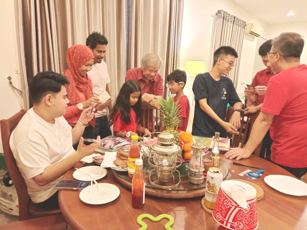 Shahril (fourth from left) and his family during last year’s Chinese New Year. — Picture courtesy of Shahril Cheah and Sharidah Talib