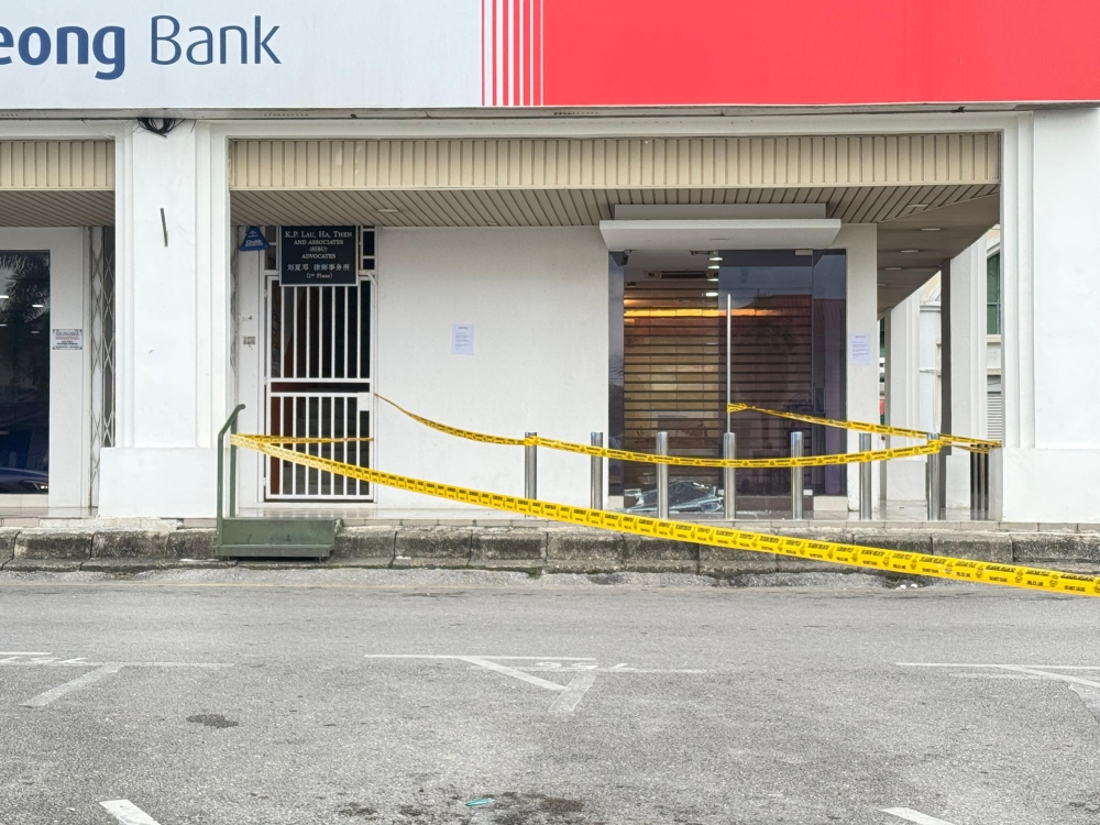Police tape is seen at the site of the shooting. — The Borneo Post pic