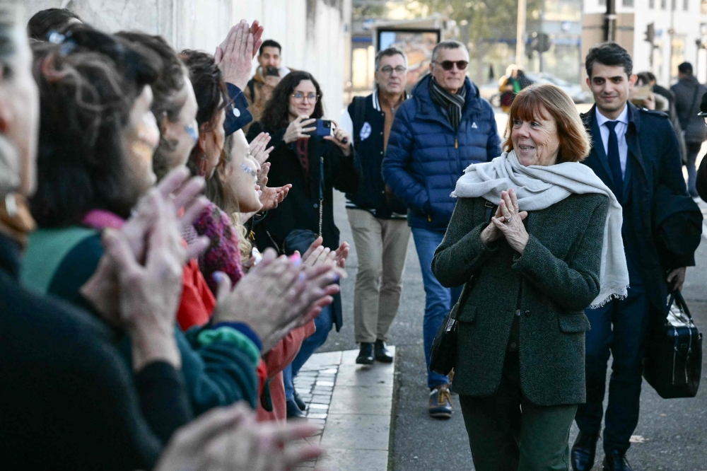 Gisele Pelicot (2nd right) followed by her lawyer lawyer Stephane Babonneau (right), is congratulated by women outside the Avignon courthouse after the prosecution concluded its case amid the trial of Dominique Pelicot accused of drugging his former wife Gisele for nearly ten years and inviting strangers to rape her at their home in Mazan, a small town in the south of France, in Avignon, on November 27, 2024. — AFP pic 