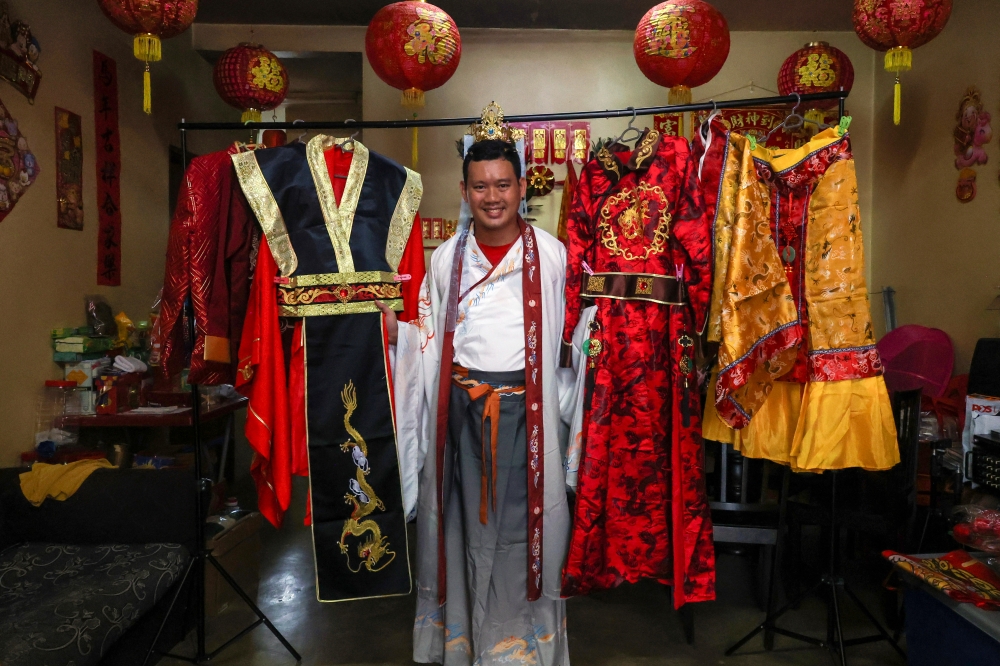 Chan Qi Yao, 33, poses with some of his more than 10 ‘hanfu’ sets at Kampung Batu Papan 2, Gua Musang. — Bernama pic  