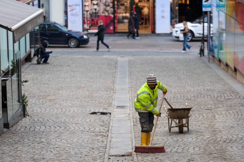 A foreign worker sweeps a street in downtown Zagreb on February 3, 2026. — AFP pic 