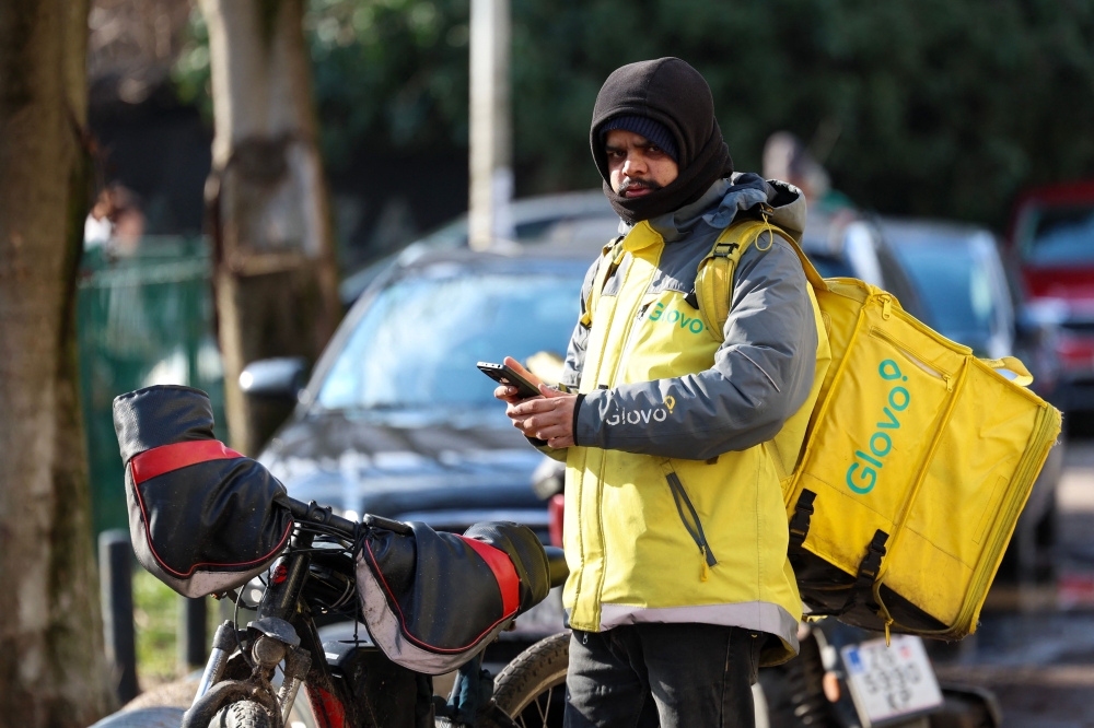 A foreign delivery worker stands next to his bicycle in downtown Zagreb on February 3, 2026. As Croatia struggles with growing staff shortages, particularly in its key tourism sector, experts warn that it is leaving its badly needed foreign workers vulnerable to violence and exploitation. — AFP pic 