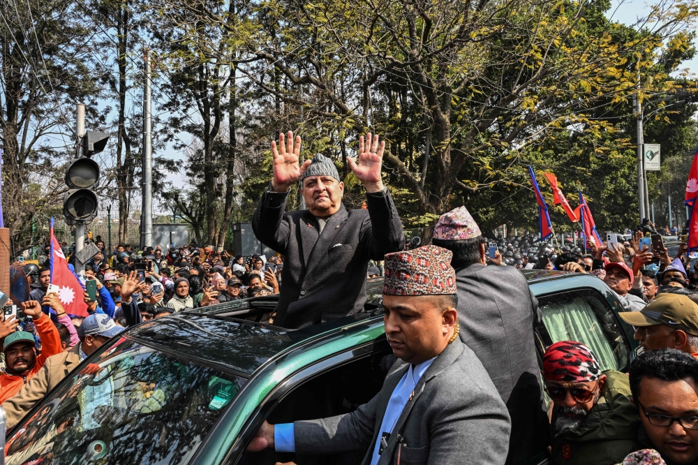 Nepal’s former King Gyanendra Bir Bikram Shah Dev (centre) greets his supporters upon his arrival at the Tribhuwan International Airport in Kathmandu on February 13, 2026. — AFP pic 