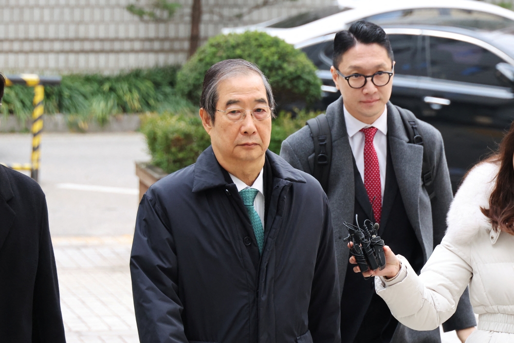 Former Prime Minister Han Duck-soo, who faces charges of allegedly aiding ex-President Yoon Suk Yeol in an attempted insurrection, arrives for closing hearing for his case at the Seoul Central District Court in Seoul, South Korea, November 26, 2025. — Reuters pic   