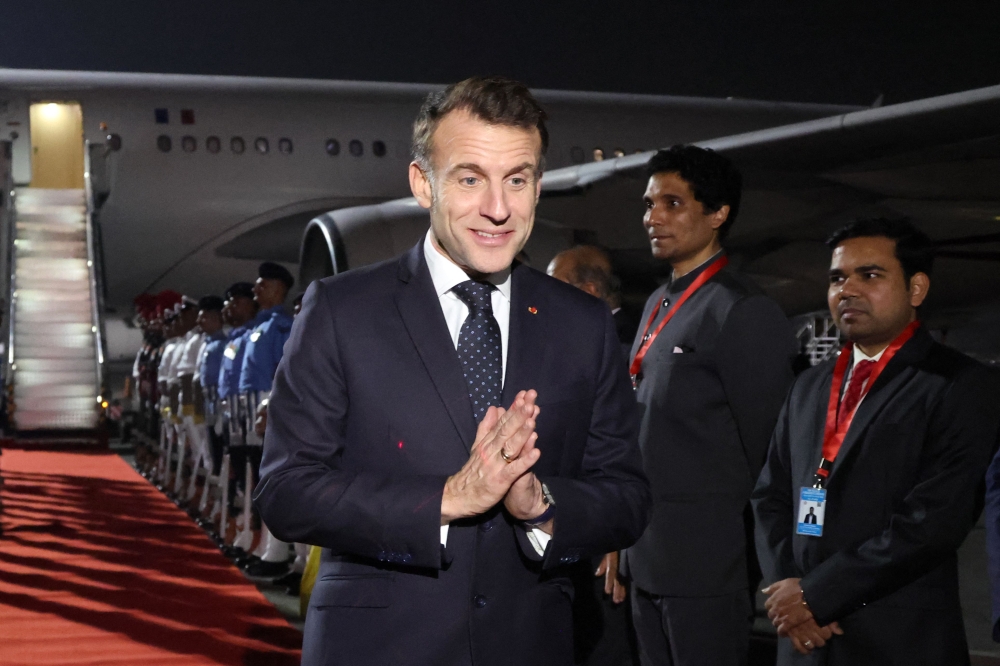 France's President Emmanuel Macron reacts as he is welcomed upon his arrival in Mumbai today. — AFP pic