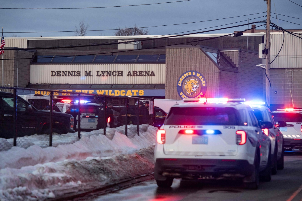 Police stand outside the perimeter they created around the Dennis M. Lynch Arena, where a shooting occurred earlier yesterday in Pawtucket, Rhode Island. — AFP pic