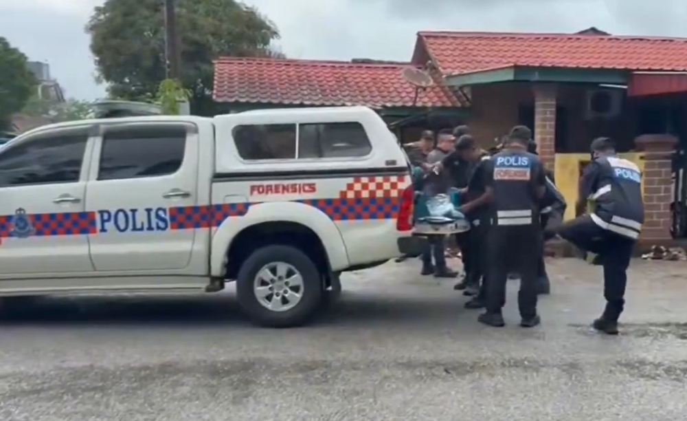 Forensics personnel conducting investigations at the house in Lorong Cherating Damai, Kuantan. — Picture from social media 