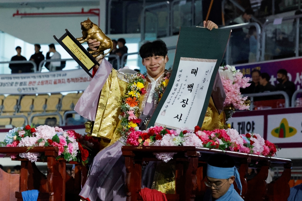 Heo Seon-haeng, a Ssireum (Korean traditional wrestling) wrestler, celebrates with the trophy after winning a Lunar New Year Ssireum championship final at the Taean Complex Indoor Gymnasium in Taean, South Korea, February 15, 2026. — Reuters pic