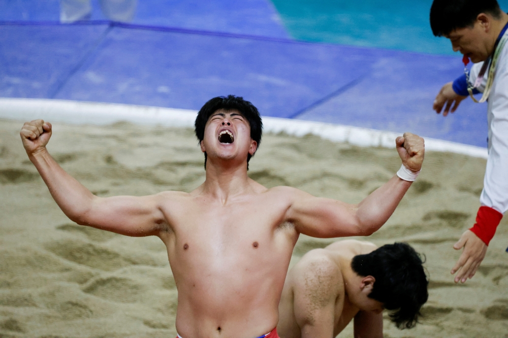 A Ssireum wrestler reacts after winning a match during a Lunar New Year Ssireum championship at the Taean Complex Indoor Gymnasium in Taean, South Korea, February 14, 2026. — Reuters pic