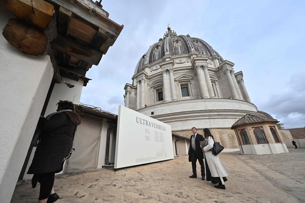 People stand on a terrace of St Peter's basilica before a press preview of the exhibition 